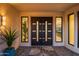 Stately double front doors with modern design, enhanced by sidelights and manicured landscaping at 11977 N 81St St, Scottsdale, AZ 85260