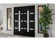 Elegant double front doors with frosted glass inserts flanked by stylish plants and modern trim at 11977 N 81St St, Scottsdale, AZ 85260