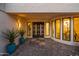 Welcoming front entrance showcases modern double doors, stylish planters, and abundant natural light at 11977 N 81St St, Scottsdale, AZ 85260