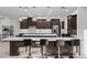 Spacious kitchen featuring a large island with barstool seating and pendant lighting at 11977 N 81St St, Scottsdale, AZ 85260