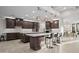 Spacious kitchen with large island, pendant lights, and stainless steel appliances at 11977 N 81St St, Scottsdale, AZ 85260