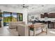 Bright living room with beamed ceiling, open to kitchen and view of golf course at 11977 N 81St St, Scottsdale, AZ 85260