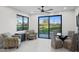 Bright living area with black framed windows, and glass table set with chairs and cozy seating at 11977 N 81St St, Scottsdale, AZ 85260