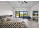 Primary bedroom showcasing backyard views, stylish decor, and tray ceiling at 11977 N 81St St, Scottsdale, AZ 85260
