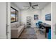 Office area with sofa, desk, and dark framed window at 11977 N 81St St, Scottsdale, AZ 85260