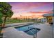Inviting pool and spa with beautiful golf course views and colorful dusk sky at 11977 N 81St St, Scottsdale, AZ 85260