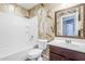 Bathroom featuring a shower and tub combination, toilet, and vanity with rustic wall decor at 13083 N 87Th Dr, Peoria, AZ 85381