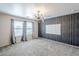 Bright bedroom featuring carpeted floors, modern lighting, and decorative wall accents at 13083 N 87Th Dr, Peoria, AZ 85381