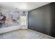A bright bedroom with a marble accent wall and a large window for natural light at 13083 N 87Th Dr, Peoria, AZ 85381