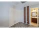 This bedroom with an ensuite bathroom features neutral colors and carpet at 13083 N 87Th Dr, Peoria, AZ 85381