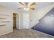 A bedroom with a closet and unique wall decor with modern fan at 13083 N 87Th Dr, Peoria, AZ 85381