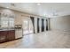 Open-concept living area features tile flooring, access to the backyard, and neutral walls at 13083 N 87Th Dr, Peoria, AZ 85381