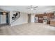 Bright open-concept space featuring tile floors, staircase and updated kitchen at 13083 N 87Th Dr, Peoria, AZ 85381