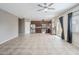 Spacious living area with tile flooring, a modern ceiling fan, and an open layout at 13083 N 87Th Dr, Peoria, AZ 85381