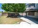 Spacious backyard featuring a covered patio and mature shade tree at 15825 W Acapulco Ln, Surprise, AZ 85379
