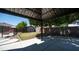 Spacious backyard featuring a covered patio, a storage shed, and lush landscaping at 15825 W Acapulco Ln, Surprise, AZ 85379