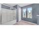 Bathroom with a shower-tub combination and two windows allowing for natural light, complemented by modern fixtures at 15825 W Acapulco Ln, Surprise, AZ 85379