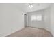 Carpeted bedroom bathed in natural light with a window and complemented by a door for easy access at 15825 W Acapulco Ln, Surprise, AZ 85379
