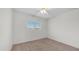Bright bedroom with neutral carpet, a ceiling fan, and a window with natural light at 15825 W Acapulco Ln, Surprise, AZ 85379