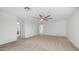 Large bedroom with neutral carpet, ceiling fan, and multiple doors offering plenty of space and access at 15825 W Acapulco Ln, Surprise, AZ 85379