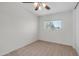 Bright bedroom featuring neutral carpeting, ceiling fan, a window, and closet at 15825 W Acapulco Ln, Surprise, AZ 85379