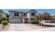 Two-story house featuring a well-kept lawn and desert landscaping in the front yard at 15825 W Acapulco Ln, Surprise, AZ 85379