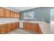 Long kitchen countertops provide generous workspaces and modern white appliances and ample cabinets at 15825 W Acapulco Ln, Surprise, AZ 85379