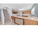 Kitchen featuring sleek appliances, wooden cabinets, and plenty of countertop space by the stairway at 15825 W Acapulco Ln, Surprise, AZ 85379