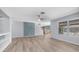 Open living area with hardwood floors, modern fixtures, and ample light with open access to the kitchen at 15825 W Acapulco Ln, Surprise, AZ 85379