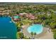 Aerial view of the community beach, pool, and lake, showcasing waterfront living at 1633 E Lakeside Dr # 25, Gilbert, AZ 85234