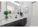 Modern bathroom with an updated vanity featuring dark cabinetry and a large mirror at 1633 E Lakeside Dr # 25, Gilbert, AZ 85234