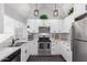 Well-lit kitchen with white cabinetry, stainless steel appliances, and modern finishes at 1633 E Lakeside Dr # 25, Gilbert, AZ 85234