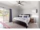 Spacious main bedroom with a ceiling fan, large bed, and private access to the balcony at 1633 E Lakeside Dr # 25, Gilbert, AZ 85234