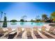 Inviting pool area with lounge chairs, swaying palm trees, and serene views, ideal for leisure at 1633 E Lakeside Dr # 25, Gilbert, AZ 85234