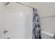 Bright bathroom includes a shower over tub, tiled walls and blue shower curtain at 1718 W Colter St # 184, Phoenix, AZ 85015
