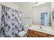 Bathroom featuring a standard toilet and sink, and shower with blue curtain at 1718 W Colter St # 184, Phoenix, AZ 85015