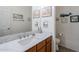 Charming half-bathroom with wood vanity, marble countertop, and nautical decor at 1718 W Colter St # 184, Phoenix, AZ 85015