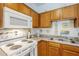 Close up on the kitchen featuring oak cabinets and white appliances at 1718 W Colter St # 184, Phoenix, AZ 85015