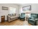 Cozy living room with comfortable seating, wood-look floors, and a serene ambiance at 1718 W Colter St # 184, Phoenix, AZ 85015