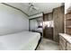 Bedroom features carpet, a ceiling fan, closet with mirror, and wooden built-ins at 17200 W Bell Rd # 652, Surprise, AZ 85374