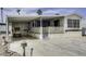 Charming single-story home with a covered parking area and a cozy front porch and meticulously kept landscaping at 17200 W Bell Rd # 652, Surprise, AZ 85374