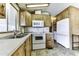 Bright kitchen area features wood cabinets, white countertops, and white appliances at 17200 W Bell Rd # 652, Surprise, AZ 85374