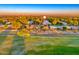 Aerial view of the community with well-maintained homes and green spaces under a vibrant sky at 18410 N 104Th Ave, Sun City, AZ 85373