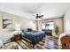 Inviting bedroom with wood floors, a ceiling fan, and an electric piano at 18410 N 104Th Ave, Sun City, AZ 85373