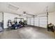 Spacious garage featuring epoxy flooring, storage cabinets, and ample room for a golf cart at 18410 N 104Th Ave, Sun City, AZ 85373