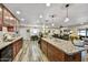 Spacious kitchen featuring granite countertops, wood cabinets, and stainless steel appliances at 18410 N 104Th Ave, Sun City, AZ 85373