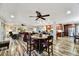 Open-concept living area featuring modern lighting, wood floors, and comfortable seating at 18410 N 104Th Ave, Sun City, AZ 85373