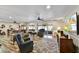 Cozy living room with comfortable seating, ceiling fans, and abundant natural light at 18410 N 104Th Ave, Sun City, AZ 85373