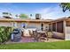 Outdoor patio with barbecue, table, chairs, and a lush green landscape provides a perfect space for relaxation at 18410 N 104Th Ave, Sun City, AZ 85373