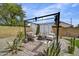 Charming backyard with desert landscaping, comfortable seating, and a stylish pergola for outdoor enjoyment at 18601 N 45Th Dr, Glendale, AZ 85308